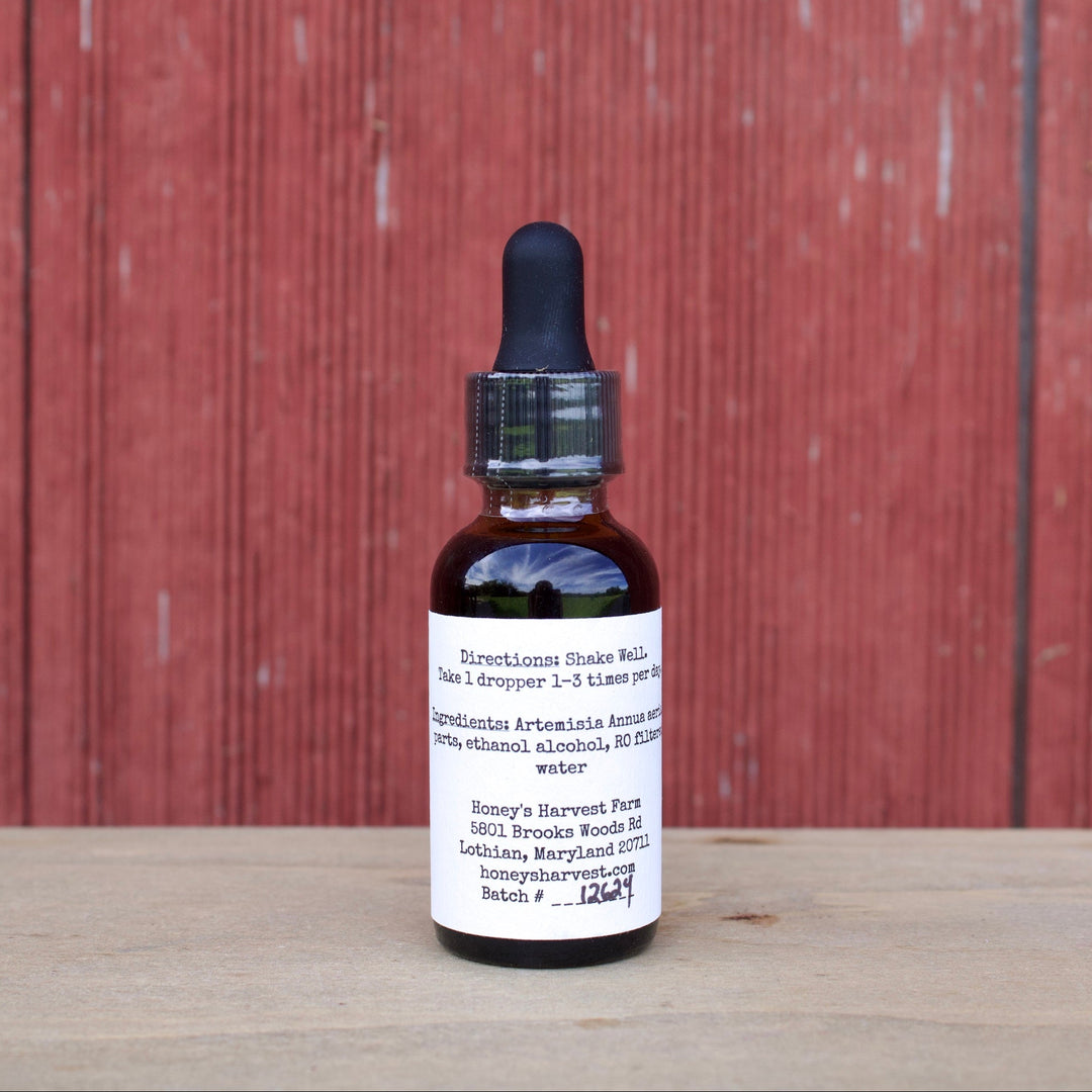 Bottle with dropper on a wooden surface against a red wooden panel background