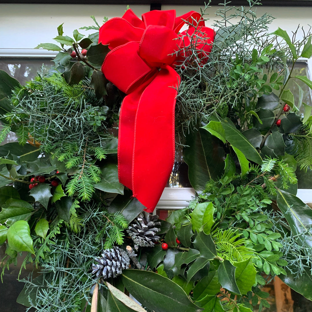 Christmas wreath with a red bow and greenery