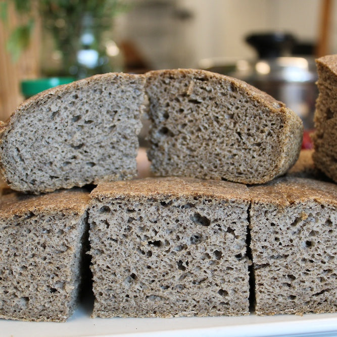 Slices of whole grain bread on a white plate with a blurred background