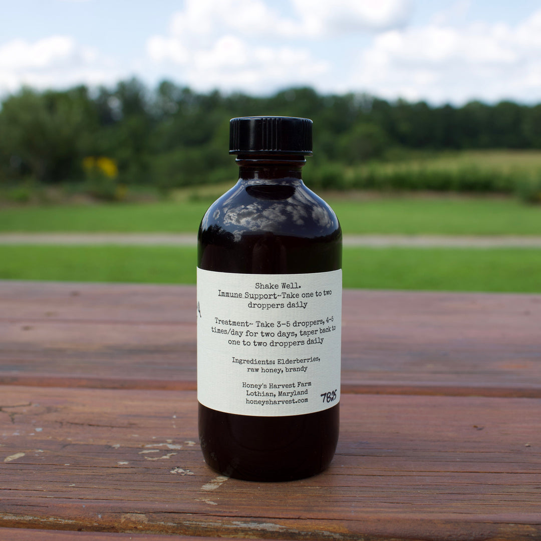 Bottle of herbal medicine on a wooden surface with a blurred natural background