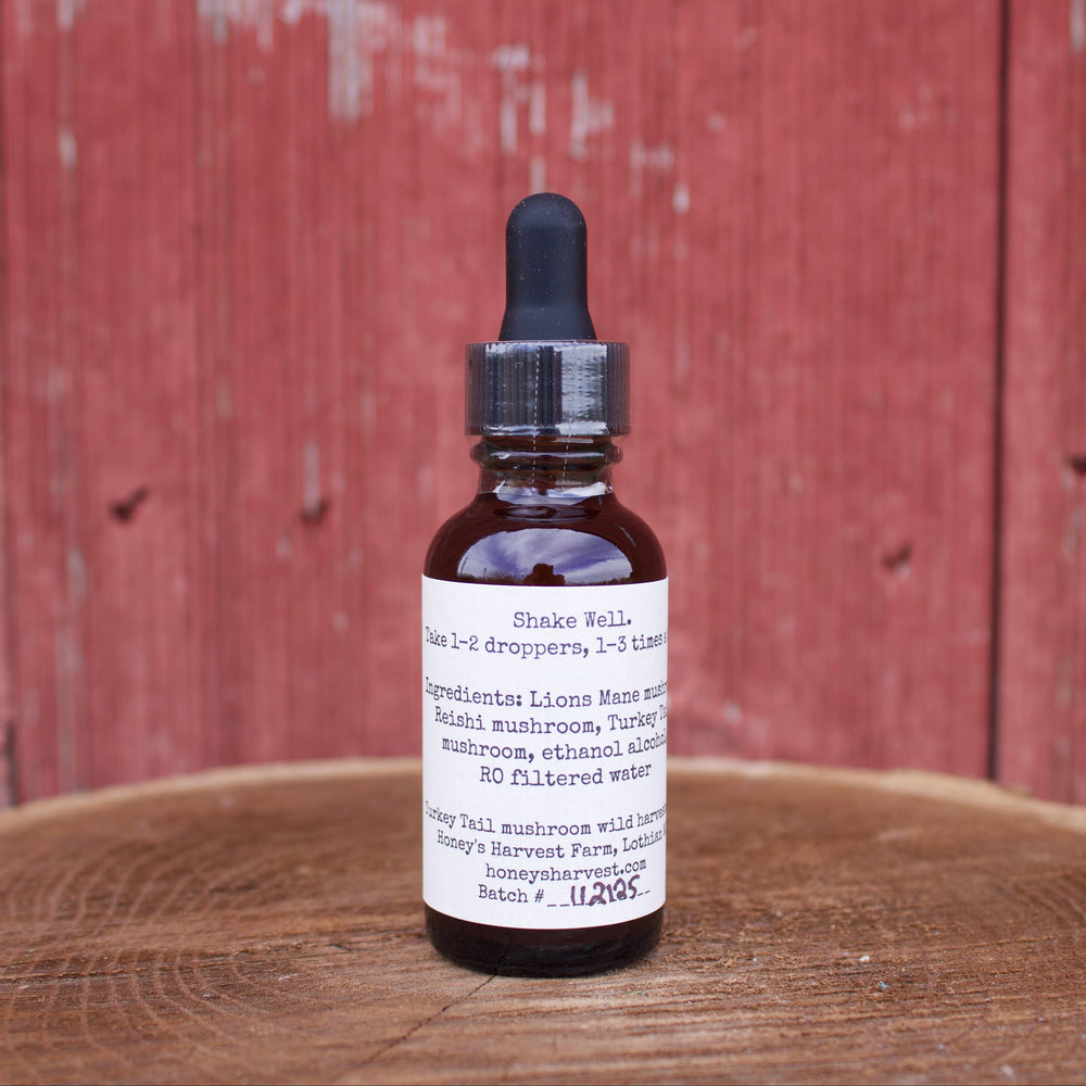 Bottle with dropper on a wooden surface against a red wooden panel background