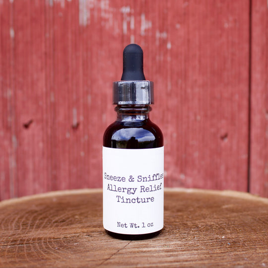 Bottle of allergy relief tincture on a wooden surface with a red wooden background