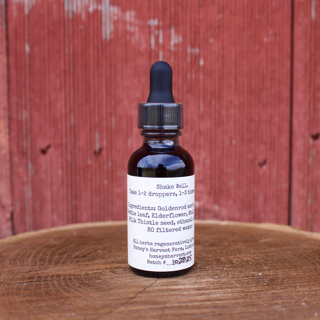Bottle of tincture on a wooden surface with a red wooden background