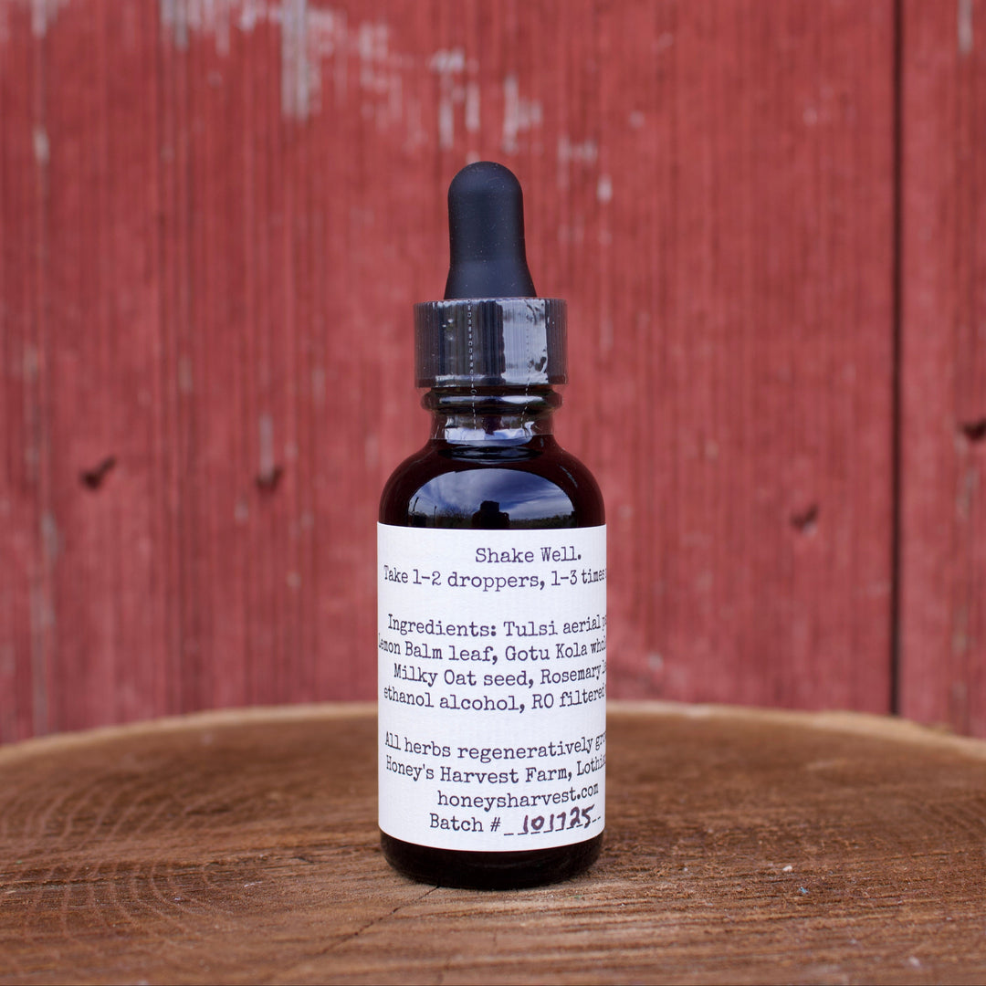Bottle of tincture on a wooden surface with a red wooden background