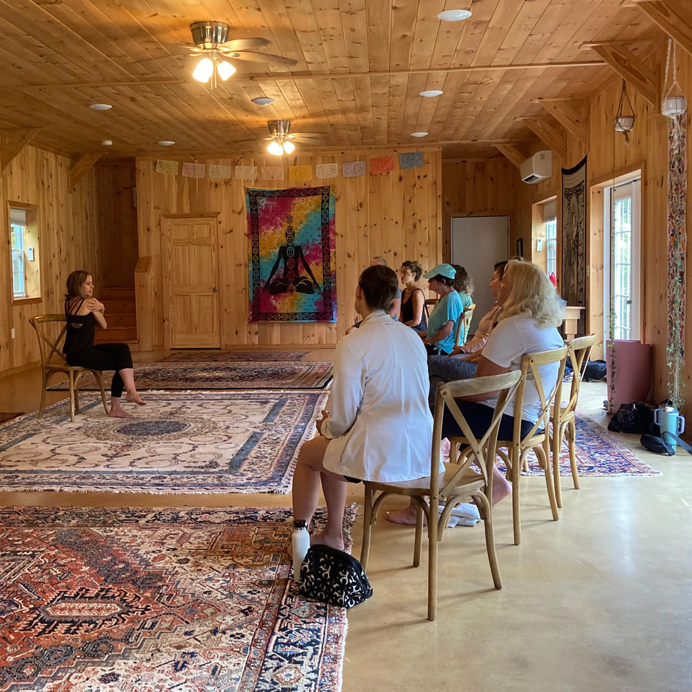 People sitting on chairs in a wooden building