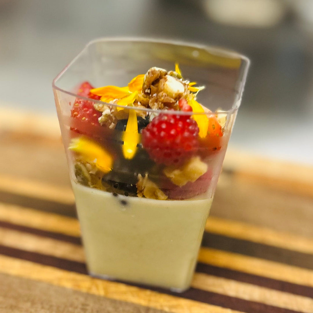 Small dessert in a clear container on a wooden surface
