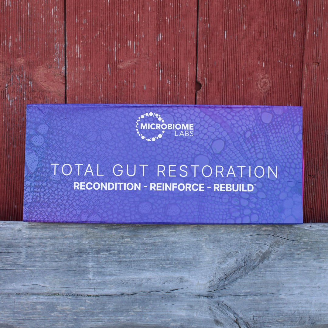 Purple box labeled 'Total Gut Restoration' on a wooden surface