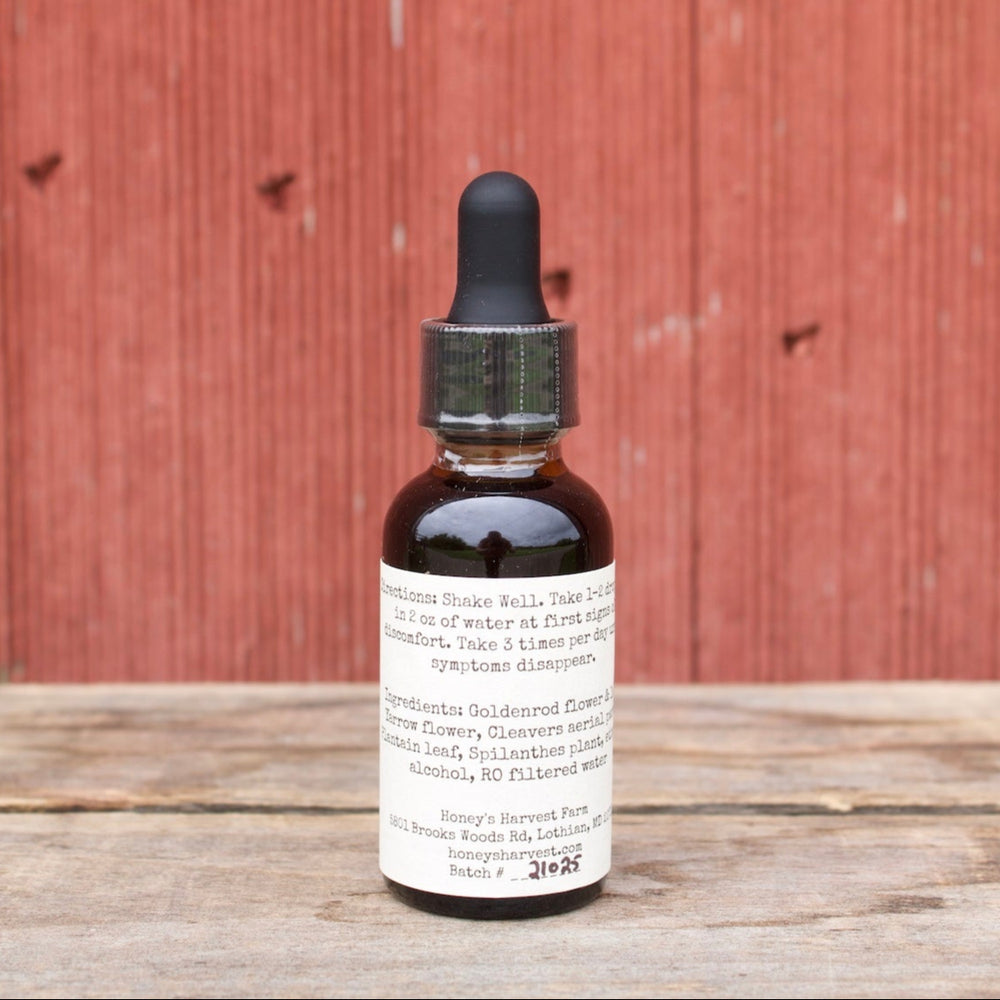 Bottle of tincture on a wooden surface with a red wooden background