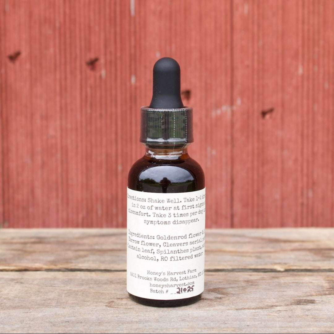 Bottle of tincture on a wooden surface with a red wooden background